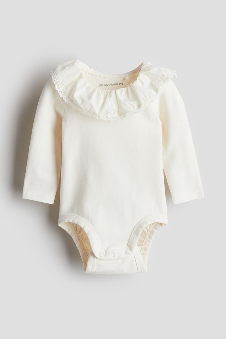 H&M Body mit Volantkragen Zeitbegrenzte Promotion